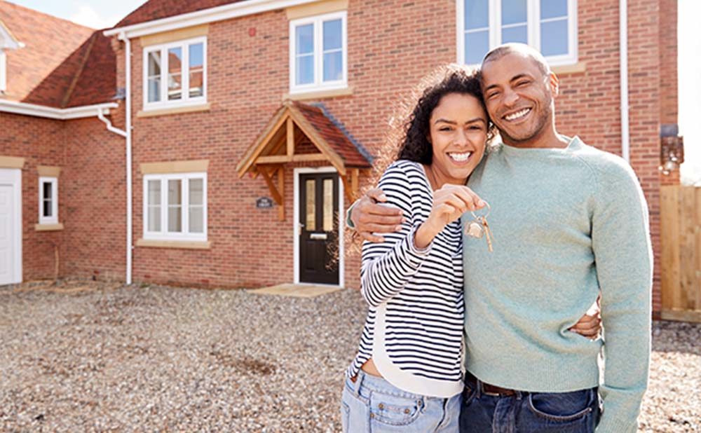 Couple after buying a new home through Homestead Financial